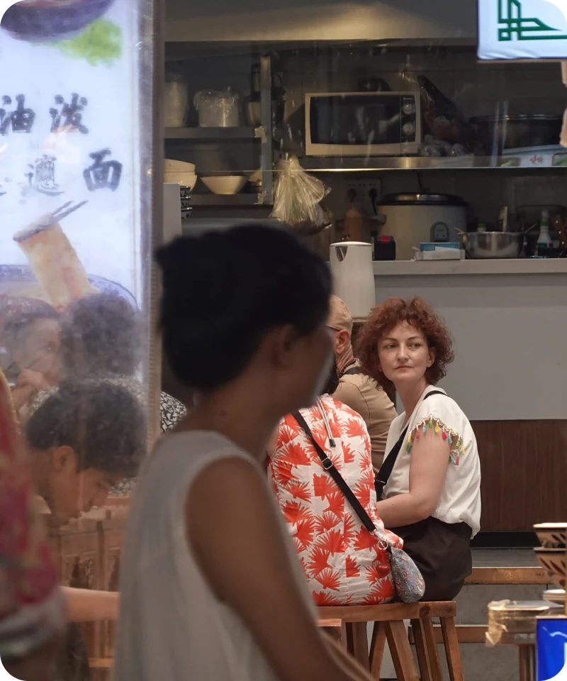 Travelers sharing a curious moment in a local restaurant
